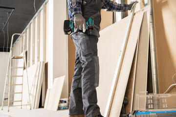 Construction Contractor Worker Preparing Drywall Boards - obrazy, fototapety, plakaty