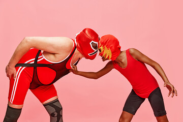 Ready to fight. Middle aged man with preteen boy stand looking eye-to-eye with competitive spirit...