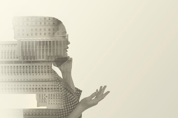 Double exposure of businesswoman and cityscape with office buildings. Space for text