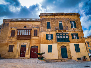 Old historical buildings in the island Malta, Valletta town, beautiful stone walls and colorful balcony, nice weather