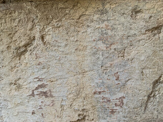 Old stone wall texture with pores and sand