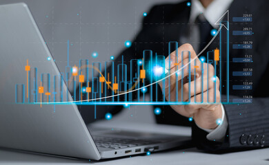 Businessman drawing virtual technical graph and chart for analysis stock market, technology...