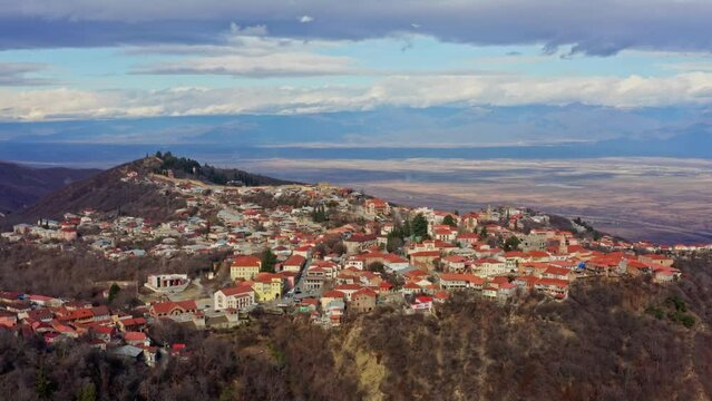 A sweeping aerial vista unveils Sighnaghi, nestled in the heart of Kakheti, Georgia, captured meticulously by a drone, revealing the town's timeless charm and scenic beauty
