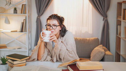 Study break. Enjoying coffee. Comfort lifestyle. Dreamy woman wrapped plaid enjoying tea having relax after learning reading cozy home interior. - 787210218