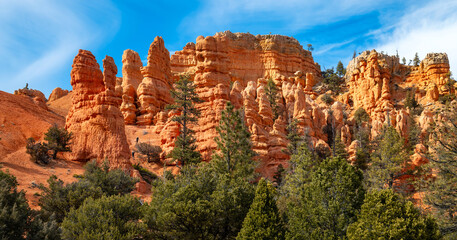 ”Red Canyon“ is a magic landscape on the way to world famous Bryce Canyon National Park, Utah (USA). Red-orange sandstone formations (Hoodoos) contrasting with blue sky and green vegetation.