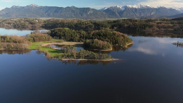 Aerial view, Staffelsee with islands, Garmisch Partenkirchen region, Bavaria, Germany near Murnau in sunny weather at sunset in spring. Drone view over islands of a large beautiful lake in Bayern. 