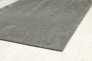 Soft grey carpet on white laminated floor indoors