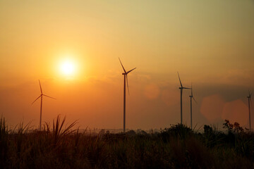 Silhouette of wind turbine field during the rising sun