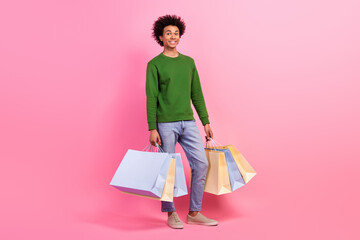 Photo of positive guy customer hold shopping bags isolated pastel color background