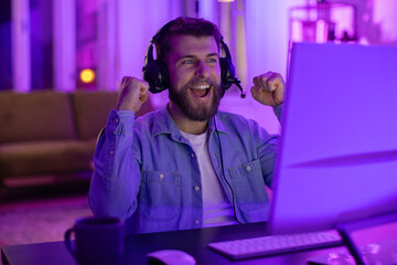 Happy gamer with headset enjoying a game