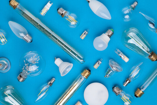 A variety of light bulbs with different sockets economy economic efficiency e27 e14 gu10 mr16 gx53 on blue background