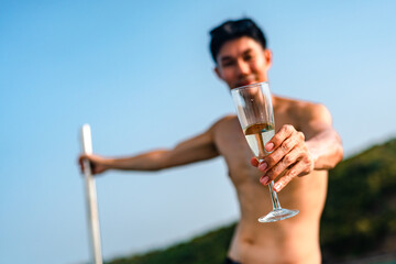 A man is pouring coffee into a cup from a gold pot. The scene is set in a natural environment, with a stream nearby. The man is enjoying the moment, as he pours the coffee into the cup