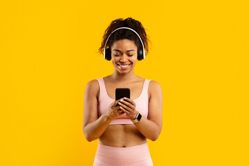 Young african american woman enjoying music on phone