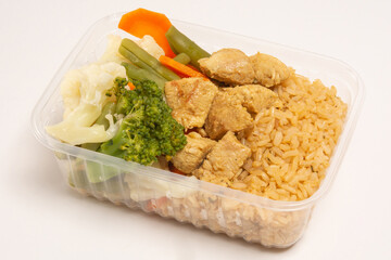 Healthy vegetables and grilled chicken packed lunch box meal in front top aerial view clean white background