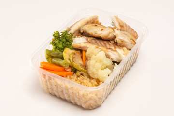 Healthy vegetables and grilled fish packed lunch box meal in front top aerial view clean white background