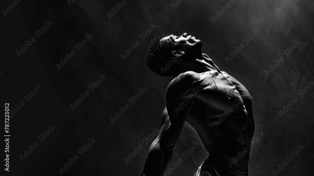 Poster amidst the deep shadows the muscles in his arms and neck stand out in sharp relief capturing the int