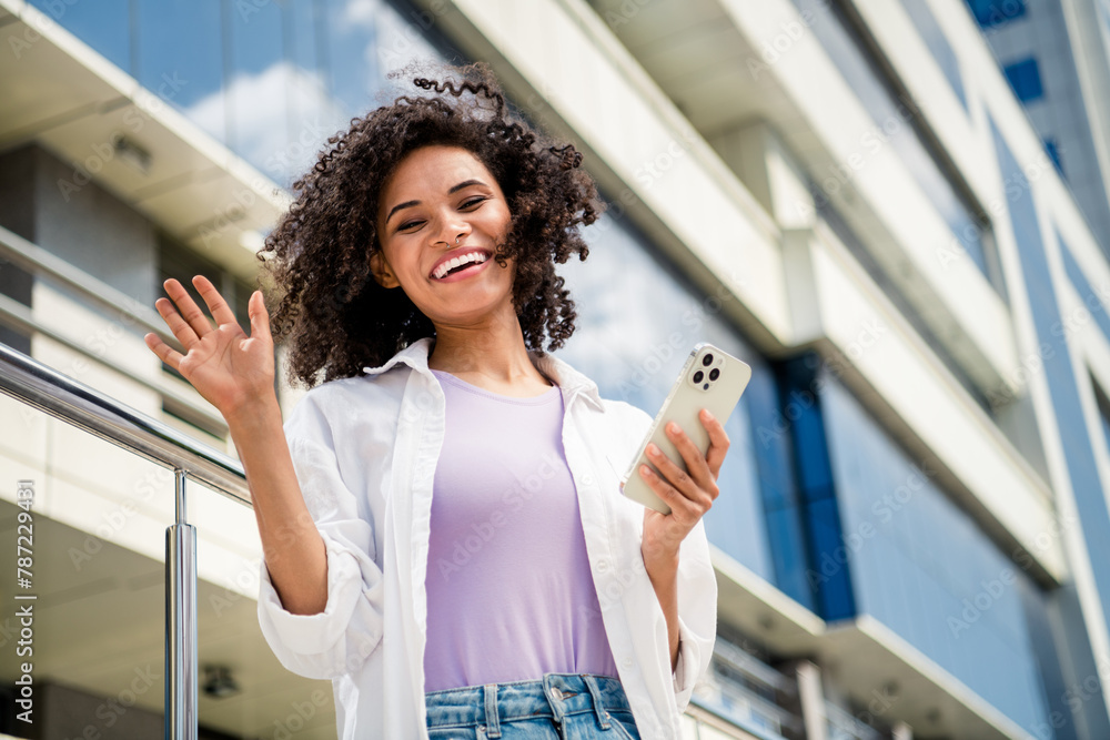 Sticker Photo of cheerful glad lovely woman dressed trendy clothes waving hand hello summer vacation travel new city outdoors