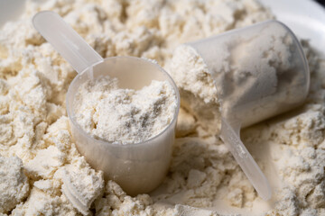 Protein whey powder with scoops. Food supplement, bodybuilding, fitness and gym lifestyle. 