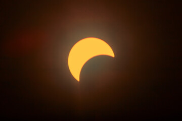 Partial Solar Eclipse with Sun's Crescent in Warm Skies