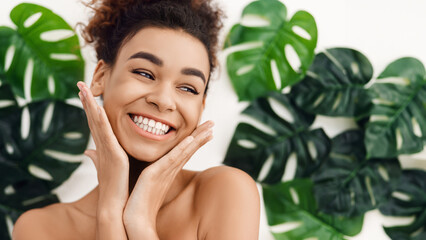 African-american girl with perfect skin over tropical leaves