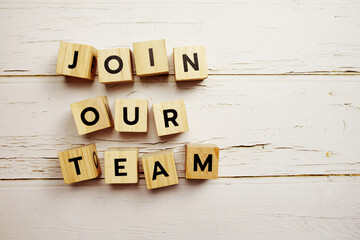 Top view of Join Our Team alphabet letters with space for text message on wooden background