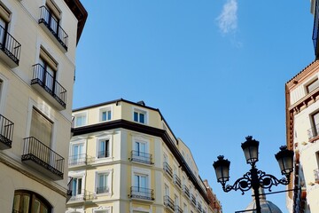 Upward look on vintage buildings of beige and yellow bright colours on the main street downtown Zaragoza Spain
