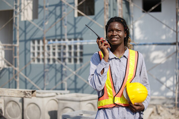 African American women general employee operational level wear yellow hard hat holding talkie...