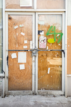 Chain and padlock on boarded up door