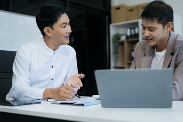 Business team working on a project in the office or reviewing and discussing a business project.
