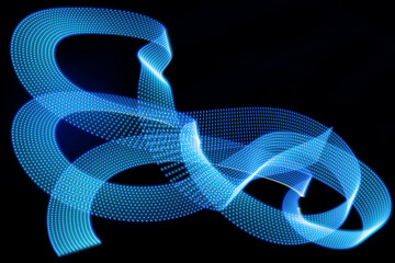 Blue neon curved wave of light as curls, spiral of dotted stripes on black background, pattern. Abstract background with motion light effect, light painting in contemporary style.