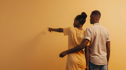 Unrecognizable african american couple holding hands and lady pointing and looking at wall with copy space beige studio background panorama back view : Generative AI - Powered by Adobe