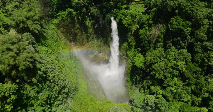 Beautiful Rainbow over Hikong Bente Waterfall surrounded by mountain jungle, rainforest and green trees. Lake Sebu. Mindanao, Philippines.