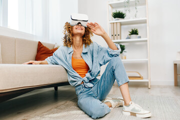 Virtual Reality: A Smiling Woman Enjoying Virtual Game with VR Glasses at Home, in a Modern Digital...