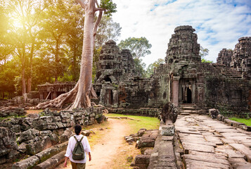 Female tourist walking to ancient Angkor temple in Cambodia - 787258494