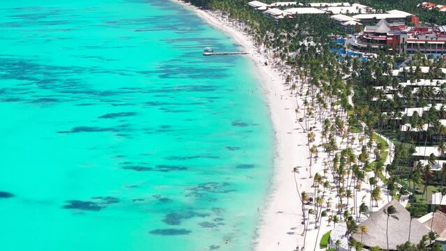 High aerial top view of the Punta Cana coast with all inclusive hotels. Large white sand Bavaro beach and turquoise water of the Caribbean sea. Best summer vacations destinations in the world