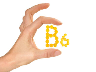 Vitamin B Pills isolated - B6 on white background with Woman Hand