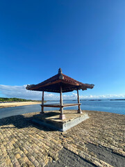 gazebo at beach against blue sky