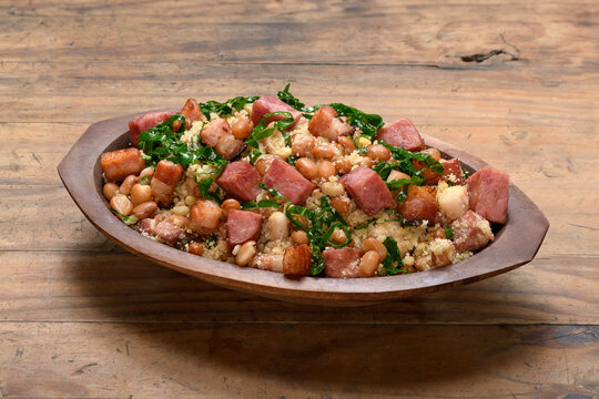 Feij&atilde;o tropeiro in a wooden container, typical food from Minas Gerais, Brazil, wooden base	