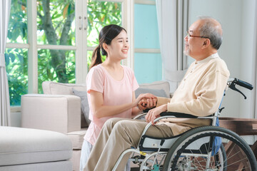 Asian family health care and insurance business at home concept, woman daughter take care support to senior elderly father patient in wheelchair together, dad having smile in happy love lifestyle