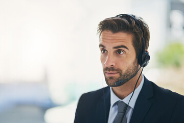 Businessman, call center and consultant with headphones for customer service or telemarketing at...