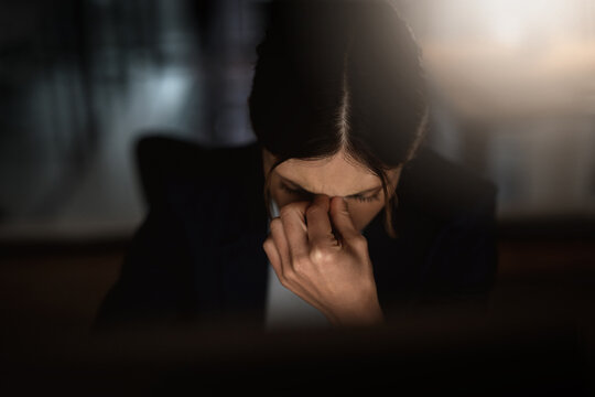 Headache, woman or stress of migraine, burnout or fatigue of business, work or mental health. Female employee, pain or head down at negative experience of tech, corporate or workaholic in office