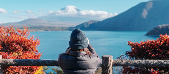 Woman tourist with Fuji Mountain at Lake Motosu in Autumn season, happy Traveler travel Mount Fuji,...
