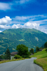 Road leading to the alpine scenery with clouds in the Austrian Alps (Schruns, Austria)
