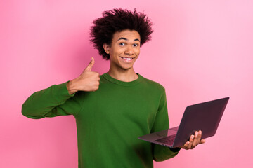 Photo of happy positive freelancer guy use netbook make thumb up symbol isolated pastel color...