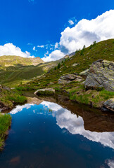Naklejka na ściany i meble Serene Mountain Lake Surrounded by Green Meadows (Austria)