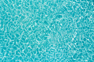 Aerial view transparent turquoise water. white mosaic under the water. pool surface pattern. calm...