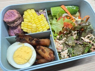 Minced pork salad, boiled egg, fried pork, brown rice, purple potatoes and corn