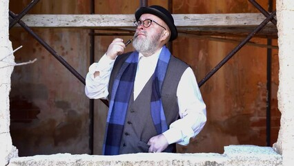 Man with beard pipe hat and vintage clothes
