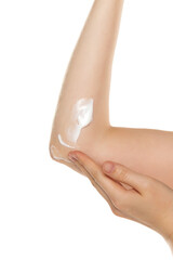 Closeup photo of woman applying moisturizer on elbow skin, care for dry elbow skin on white background