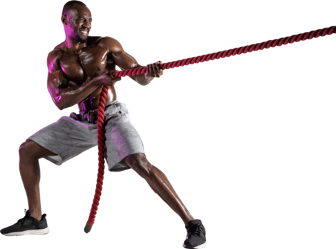 Muscular, athletic, shirtless African-American man training, pulling fitness rope isolated on transparent background. Strength and endurance. Concept of sport, active and healthy lifestyle, action